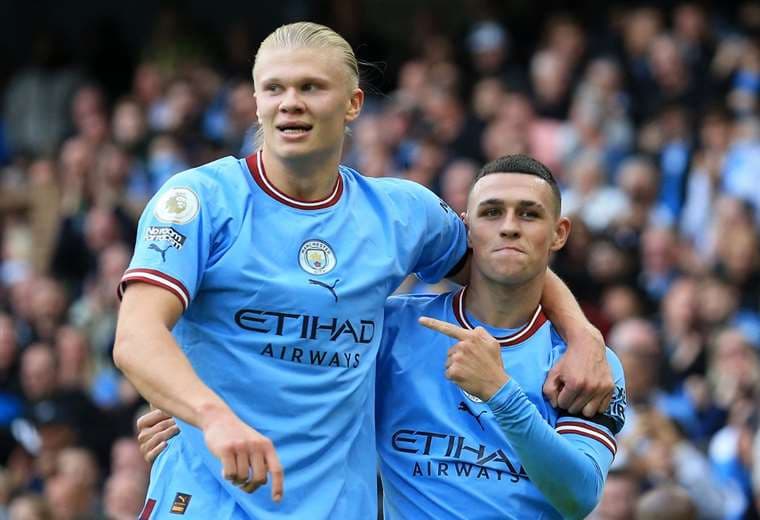 Erling Haaland y Phil Foden. AFP